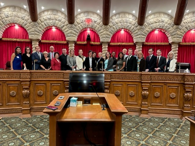 Volunteers from the top ten sections pose behind the court room bench with Nevada Supreme Court Justices and Nevada Court of Appeals Judges. 