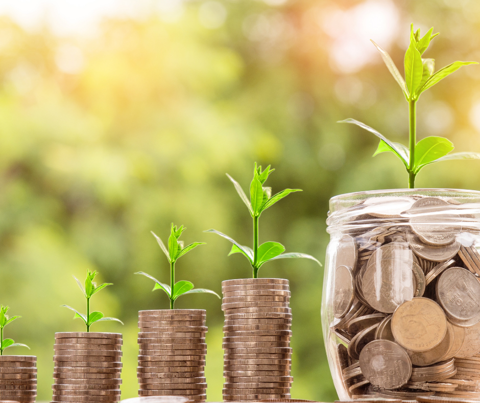 Savings concept with plants growing on coin piles and coins in a jar