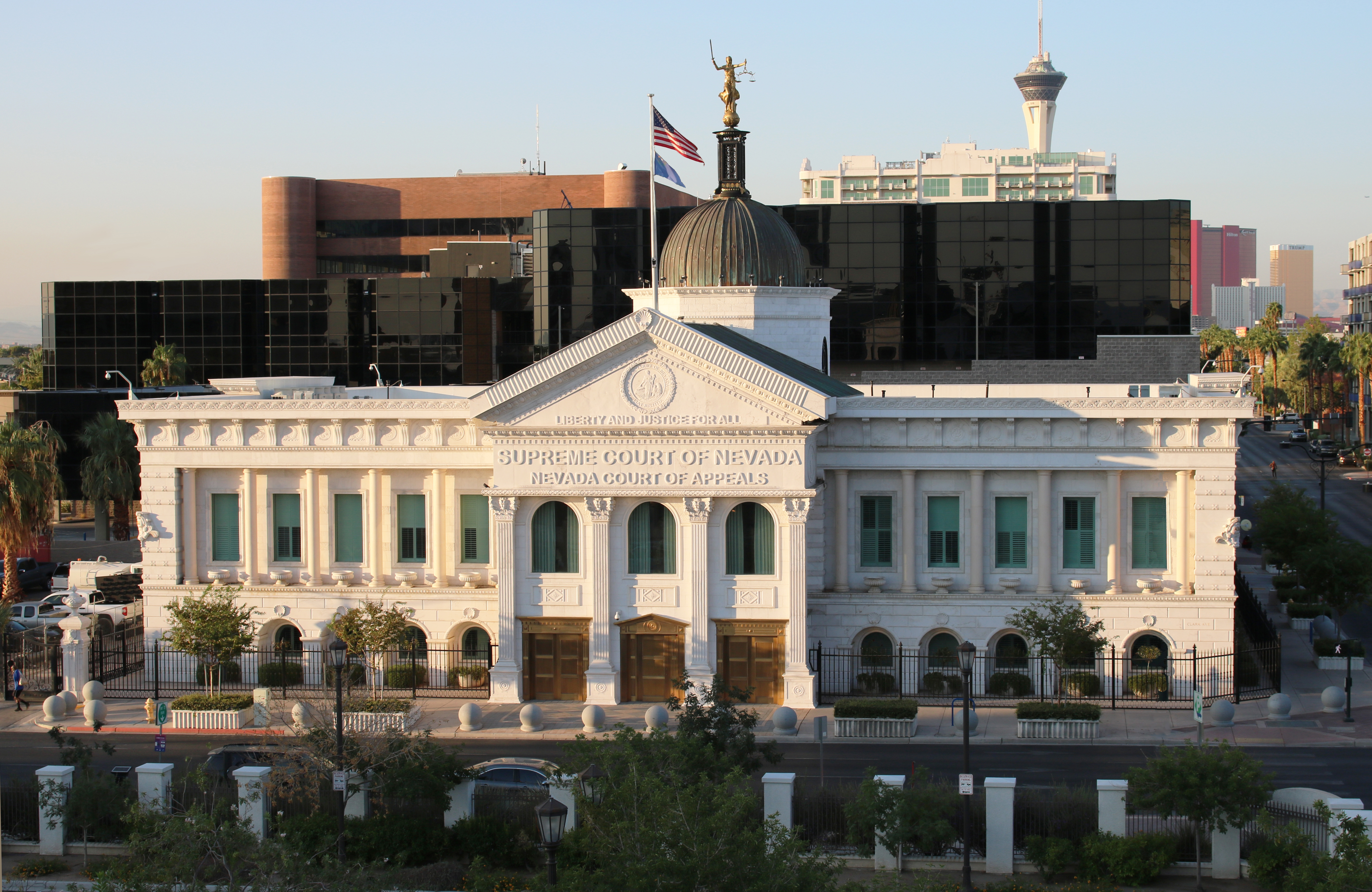 Photo of the Nevada Supreme Court house in Las Vegas. the photo is taken at sunrise and other buildings can bee seen in the background